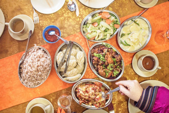 3.	A typical Bhutanese meal consisting of various dishes, including red rice, cheesy potatoes, vegetables, chicken and chili. Red rice, one of the rarest types of rice on earth, is cultivated in the fertile valleys of Bhutan © Mesa Studios