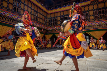 5.	Two Buddhist monks beat their drums during the yearly Masked Dance Festival in Paro. This important religious celebration is held widely over Bhutan in various monasteries and dzongs © Maurice Brand