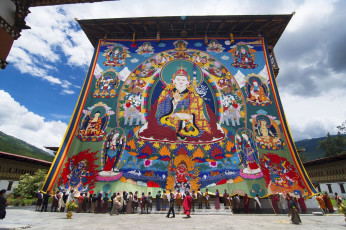 6.	Monastic fortresses called dzongs are found all over Bhutan and are the venues for the annual three-day Tshechu Festivals. In the picture people assist the monks to roll up the huge Thangka. The unveiling of this huge religious image is a highlight of the festivities and takes place on the last day of the festival © Jiali Chen