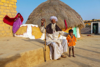 An Indian family lives in a traditional village or hut house near Jaisalmer, Rajasthan, India © Yavuj Sariyildiz