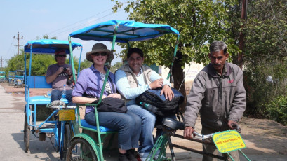 Foreign travelers with the riders, enjoy the Rickshaw Safari through the Keoladeo National Park which is a vast bird sanctuary in Bharatpur, Rajasthan, India.