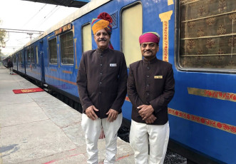 Serving staff sport a smile for the camera. Recently the Palace on Wheels Train changed it’s exterior and interior colors from a mustard yellow to dark blue © Dave Brett / Flickr