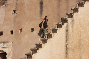 A tourist ascending steps in the massive Bundi Palace in Rajasthan. The palace is famous for its glorious turquoise and gold murals © Don Mammoser