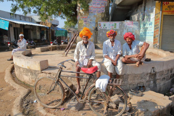 Three men in colorful turbans while away the time in a village near Bundi © Christophe Cappelli