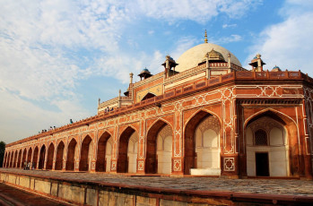 A grand view of Humayun's Tomb which is built primarily in red sandstone. The monument is a perfectly symmetrical structure with white marble double domes capped with 6 m long brass finial ending in a crescent, Delhi, India © Gritsana P