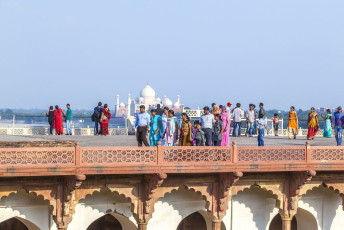 Tourists explore the beautiful Red Fort in Agra, India. They also get to enjoy the view of the majestic Taj Mahal from the top of the Fort at noon © Jorg Hackemann