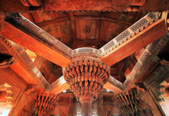 Elaborately carved Red Sandstone embellishment for the ceiling by sandstone pillars at Fatehpur Sikri. @ Mikadun