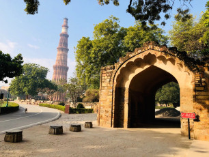 The entrance to the Qutub Minar Complex in New Delhi with the 239.5 ft./73 m-high Tower of Victory built in 1193 in the background. The complex is a World Heritage Site - Photo By  Azhar_khan