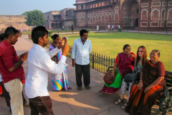 Locals take a picture with a foreign tourist with members of their family at Fort Agra. The fort served as the main residence of the Mughal emperors until 1638 and is often referred to as the Red Fort because of the red sandstone used for its construction - Photo By  Don Mammoser