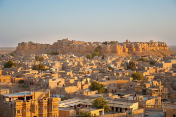 A scenic view of Jaisalmer, also known as the Golden City of Rajasthan. It is called so because the yellow sand and the yellow sandstone used in every architecture of the city gives a yellowish-golden tinge to the city and its surrounding area. Rajasthan, India. © RuthChoi
