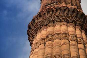 The Qutab Minar in Delhi against a rare blue sky, one of the most popular attractions. © PigginFoto