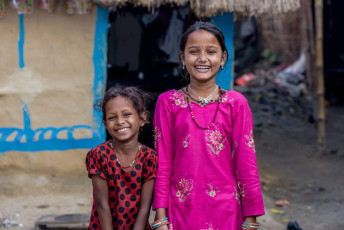 Two young girls smile for the camera at Pushkar in Rajasthan. © Travel Stock