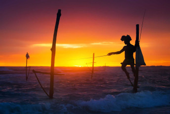 A stilt fisherman is up at the crack of dawn. Although stilt fishing is practiced all over Asia, it is most common among the inhabitants of Ahangama, a small village in Sri Lanka © Anton Jankovoy