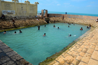 Boys enjoying the healing powers of the water tank adjacent to the famous Keerimalai Naguleswaram Hindu Temple in Jaffna. The tank is filled by a natural underground spring © imranahmedsg