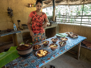 A young rural woman preparing a traditional meal of rice and curry in her kitchen in the small eco village of Hiriwadunna, Sri Lanka © Jana Kollarova