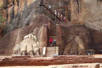 Visitors climb up the steps past the claws, the only part of the Lion Rock gateway of Sigiriya that survived the ravages of time. This ancient rock fortress is a World Heritage Site © slava296