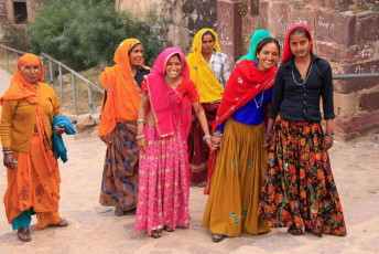 Women smile at the camera as they walk around Ranthambore Fort. It is one of the six forts included in the World Heritage Site "Hill Forts of Rajasthan", India. © Don Mammoser