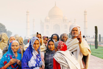 The Taj Mahal sees the Indian visitors praising its beauty at sunrise, Agra, India. @ Regien Paasse