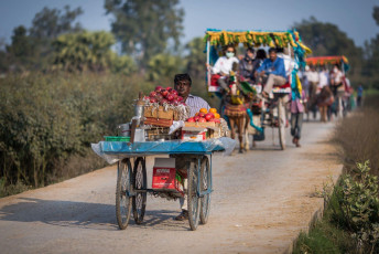 On their way to Bundi, a man pushes a food trolley and tanga riders take the travelers. © Songpol Jesda-apiban