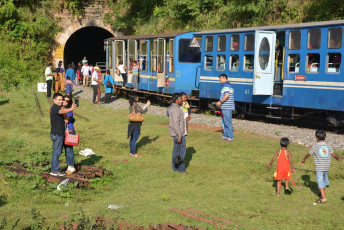 A number of tourists stand in front of the famous Nilgiri Toy Train taking their pictures and selfies in Ooty, UNESCO World Heritage Site. © Rklfoto