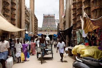 A congested street scene in front of the Sri Meenakshi Hindu Temple which is visited by the locals and pilgrims, with many stalls and shops on either side of it in Madurai, Kerala, India. © Jaume