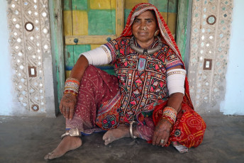 A tribal woman from the rural areas of Kutch in Gujarat, wearing traditional jewellery and attire representing the community.
