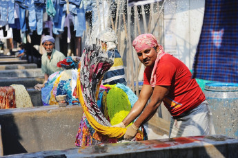 A man washing clothes at the Dhobi Ghat Laundry District, which is a well known open air  laundromat in downtown Mumbai. © Wantanddo