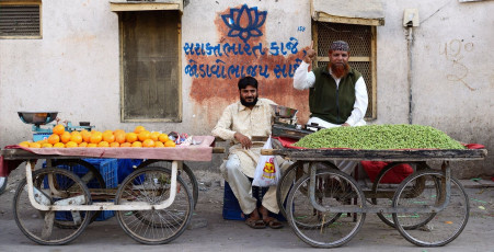 Fruit sellers from the Muslim community pose with their fruit carts on the streets of Junagadh city in Gujarat. © Rafal Chichawa