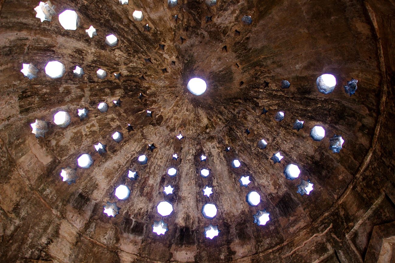 Star-shaped openings adorn the ceiling of the hammam in the palace complex, Mandu