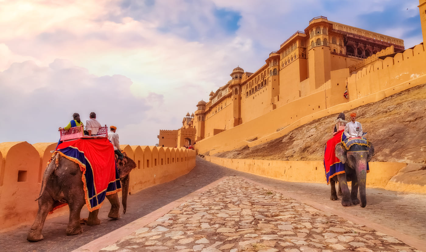 Tourists enjoy elephant ride at Amber Fort Jaipur at sunrise.