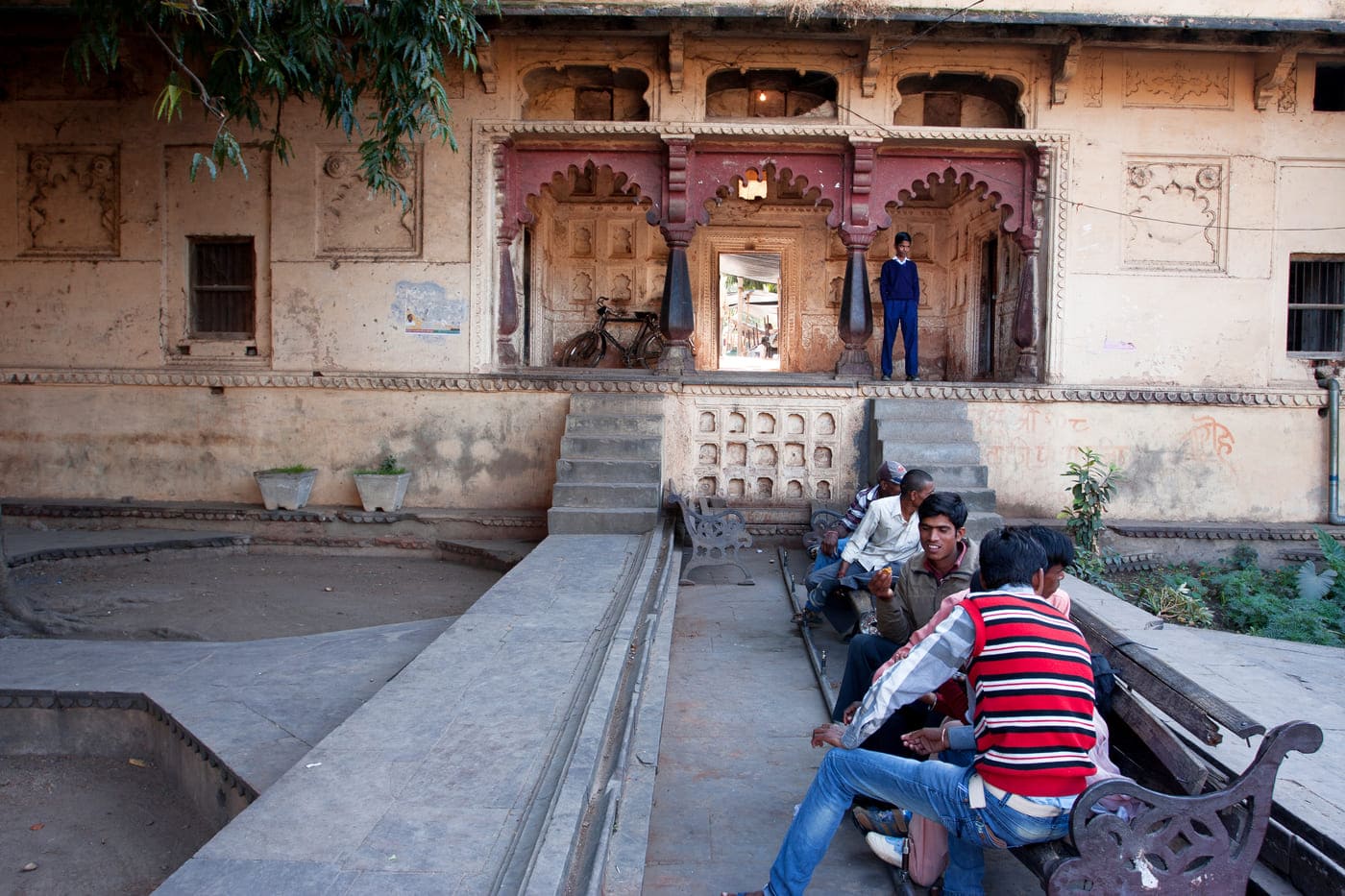 A group of Indian teenagers meet up in the old city garden in Orchha, Madhya Pradesh, India. The place attracts both locals and tourists alike because of its unique architeture 