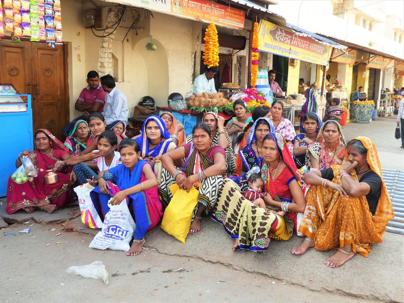 A group of women and young girls sitting on the street in Orchha 