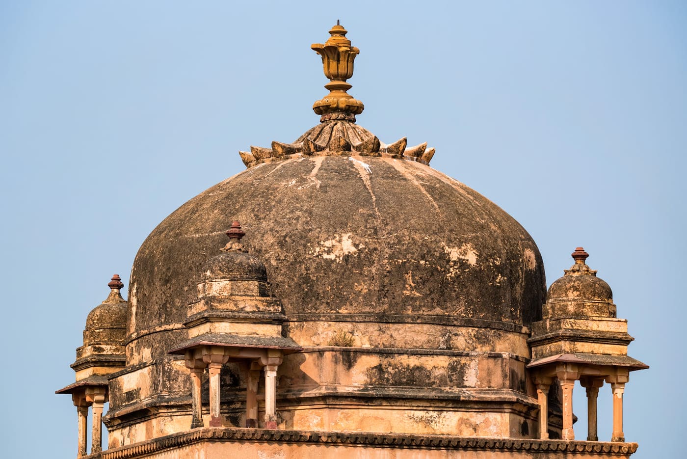 A shot of one of the many cenotaphs at the Orchha Fort Complex against the bright blue sky in Orchha, Madhya Pradesh 