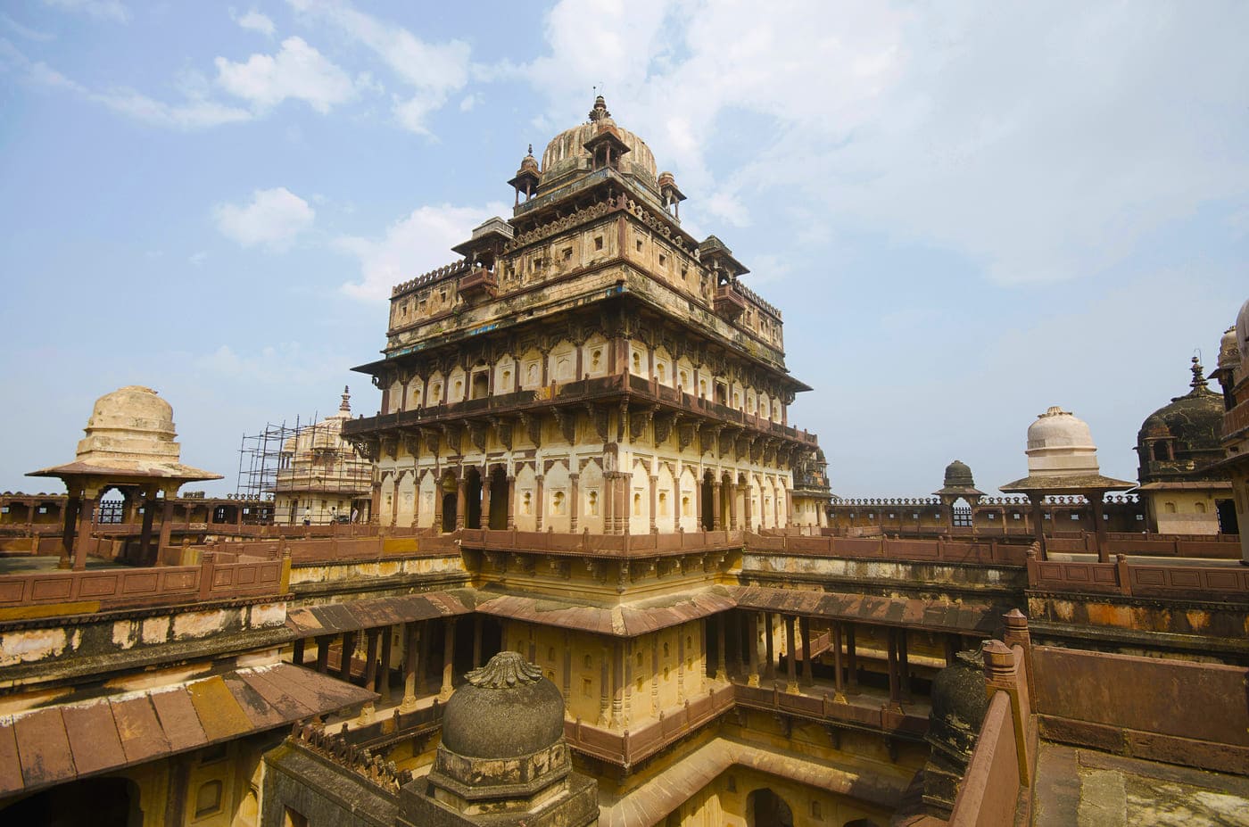 An elevated shot of the upper half of the Datia Palace that shows its extensive structure complete with complex designs and carved structures on the roof, Madhya Pradesh 