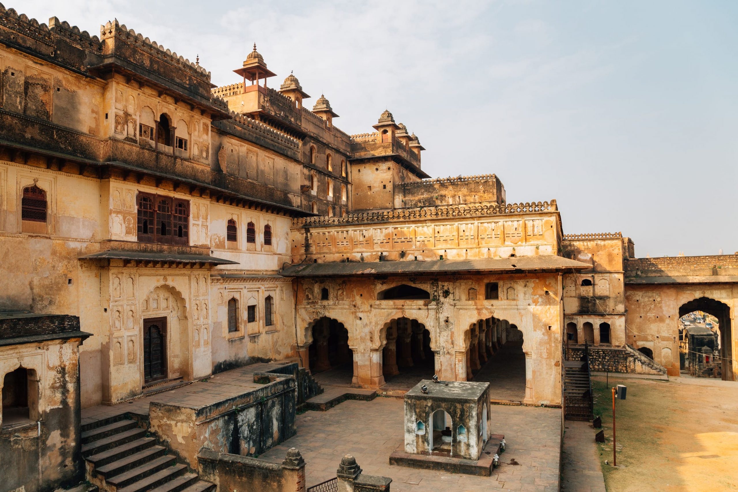 An exterior view of decorated latticed windows and archways of Raj Mahal situated in the Orchha Fort complex 