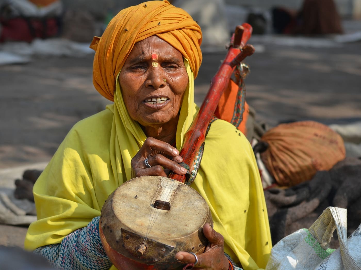 Old Indian temple musicians playing the rectangular Indian tambourine (jheeka) and singing at Ram Raja Mandir, Orchha 
