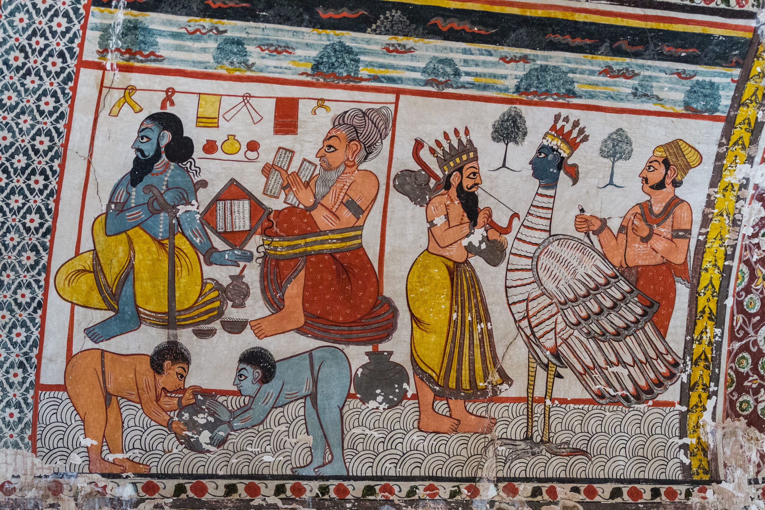 On the right is a painting of Garuda, Lord Vishnu’s eagle mount. The scene has been taken from the Hindu epic Ramayana, and shows Lord Rama and his brother Lakshman, at war with Ravan in Sri Lanka, when they were attacked by Meghnath with a nagpash, or cobra arrow. The arrow created thousands of cobras which gripped Rama and Lakshman. In this picture Narad Ji , the messenger god gives instructions to Garuda to save the lives of Rama and Laxman. On the left holy men are getting ready for their daily routine, while down below two young boys are practicing their wrestling skills, Orchha