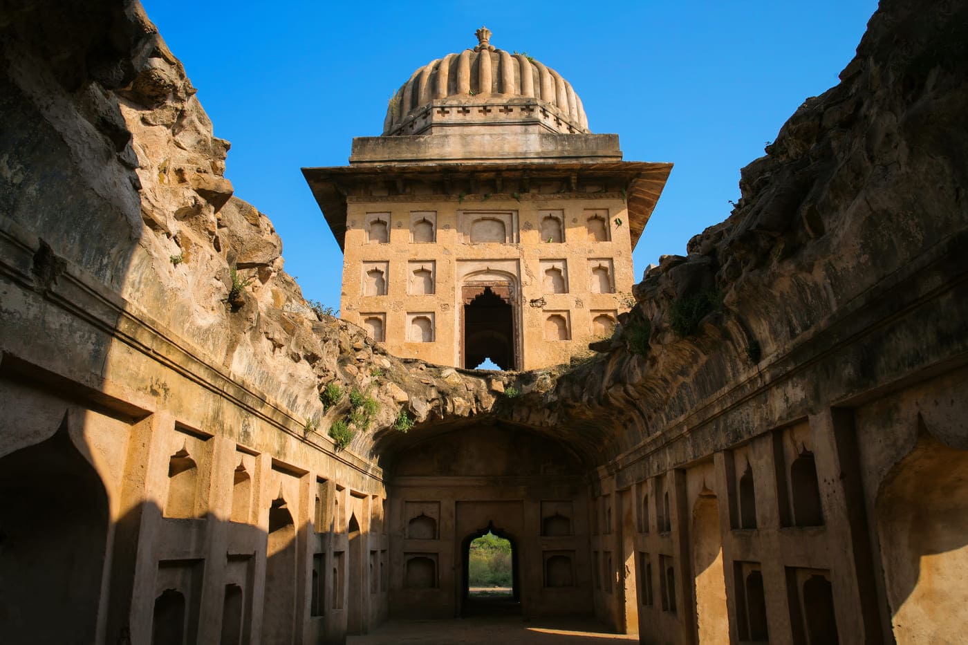 The collapsed ceiling of once an assembly hall of the Orchha Palace is now one of the most spectacular ruins of the area, framing the sky with its traditionally vintage walls