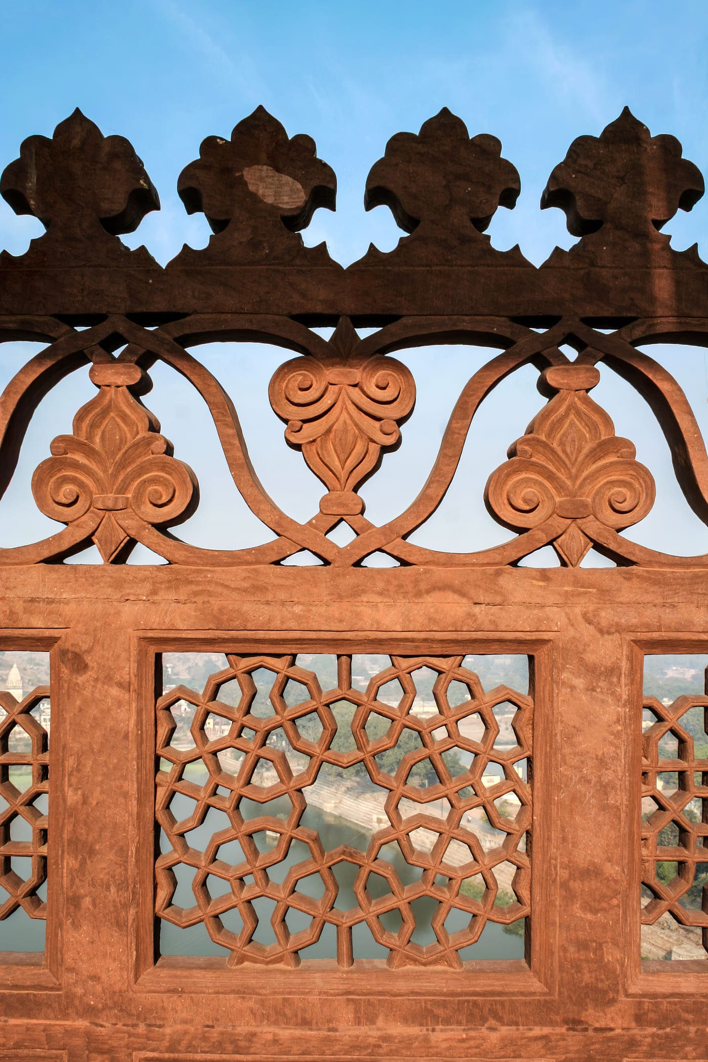 The railing of an open balcony passageway at the Datia Palace shows the skilled craftsmanship of the artisan who carved careful patterns onto single pieces of stone that then became the railing, Madhya Pradesh 