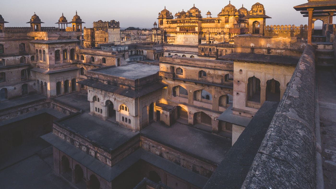 The setting sun casts a golden light onto the Jahangir Palace at the Orchha Fort complex, making for an incredible illusion as if the stones are on fire 