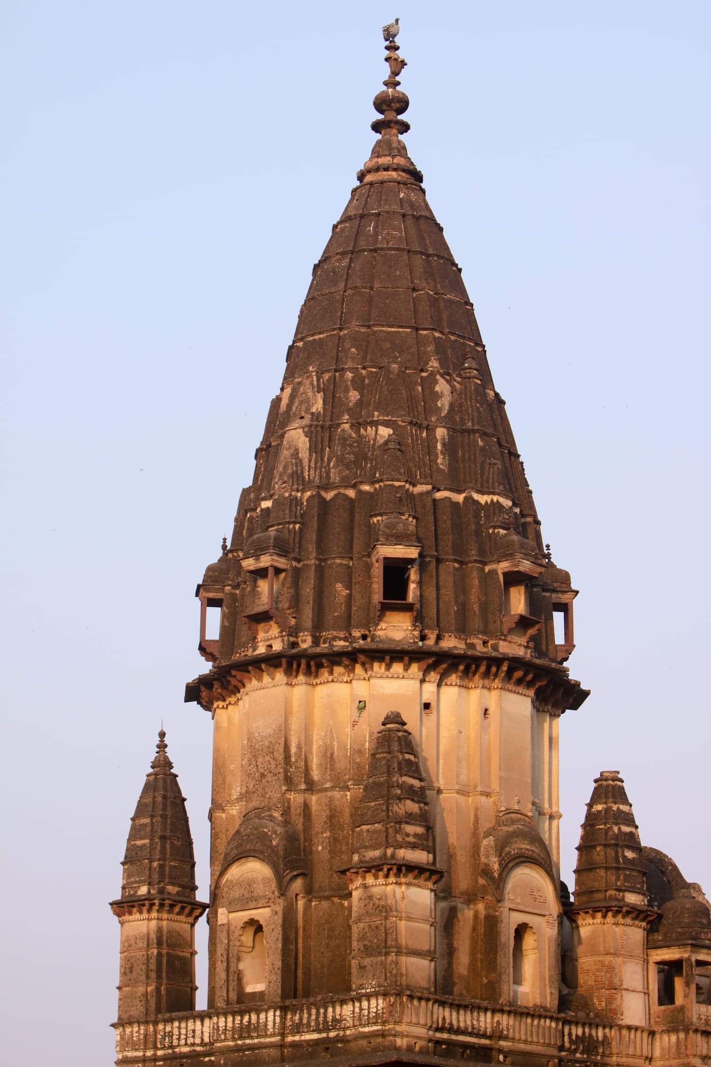 The shot of an ancient temple with multiple stories and unique architecture in the idyllic town of Orchha set on the banks of Betwa river