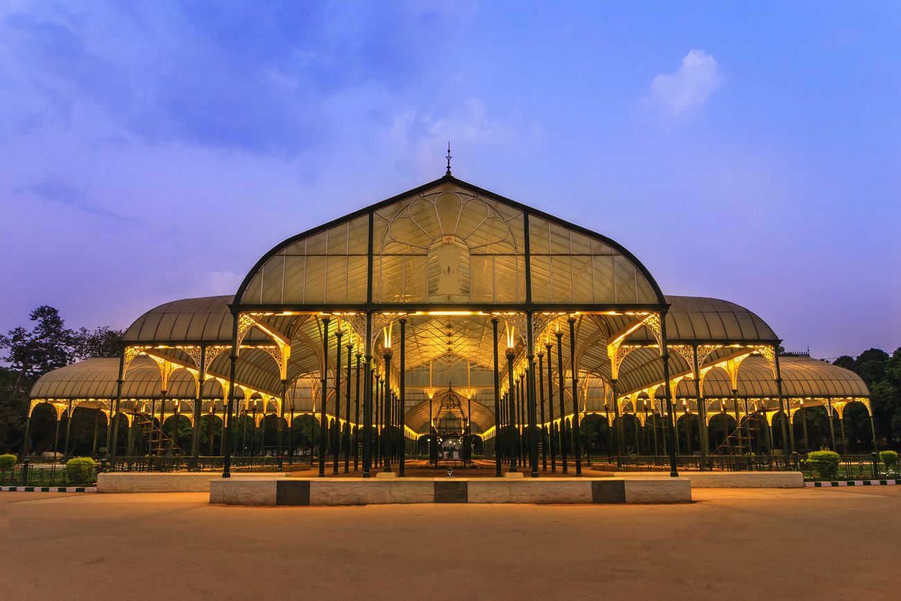 A stunning night scene of Lalbagh Park which is a botanical garden and also has a glass house and lake inside in the City