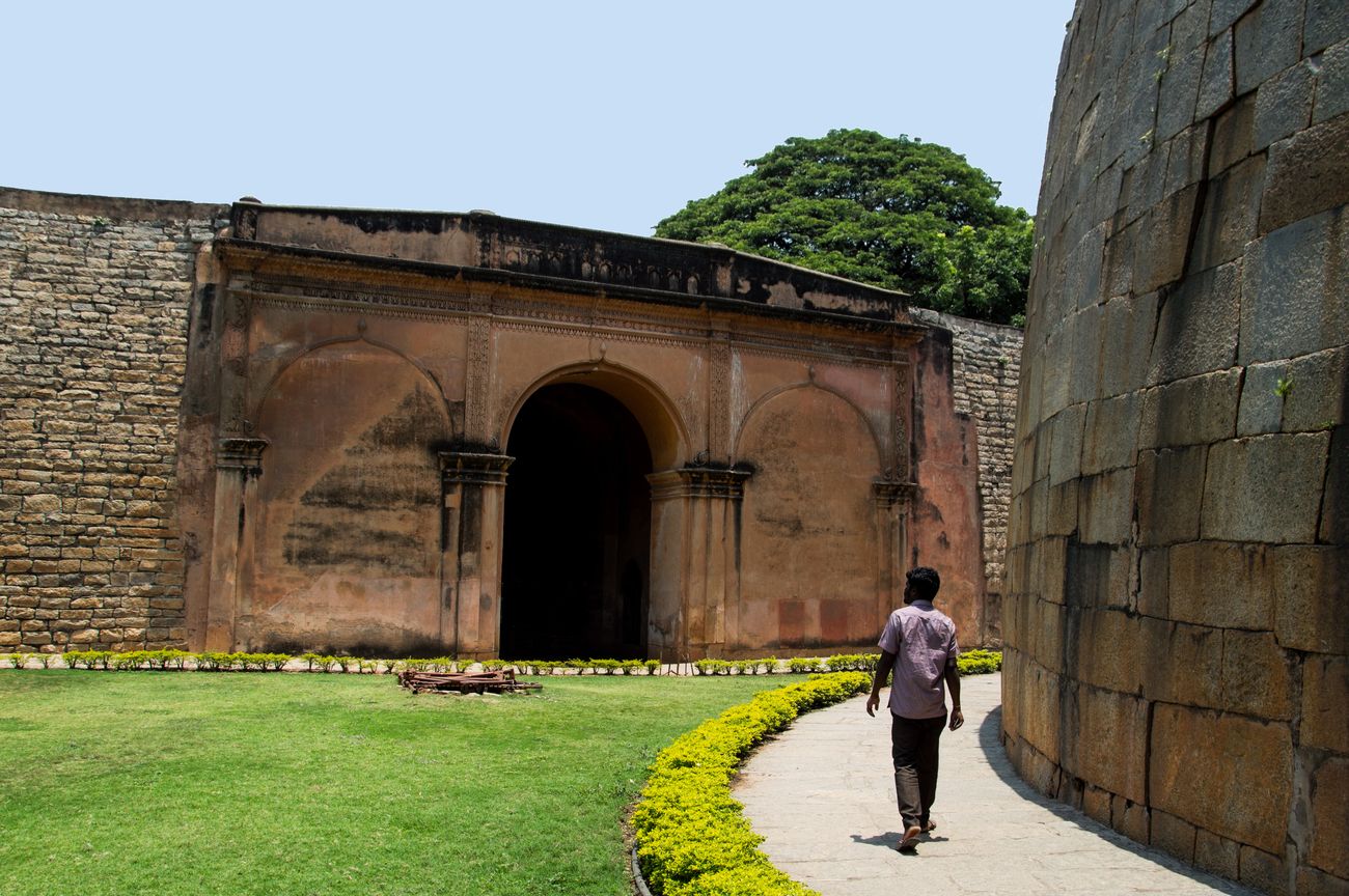 A tourist walking inside the Bangalore fort which is a powerful edifice of Indian history, also known as Tipu Sultan’s fort that stands testament to the rich history of the Kingdom of Mysore