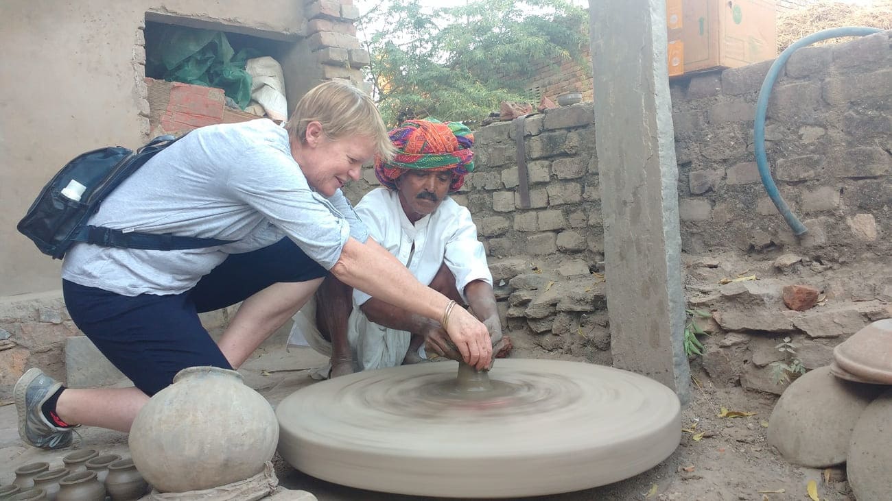 A village potter instructing a visitor on the skills of his craft