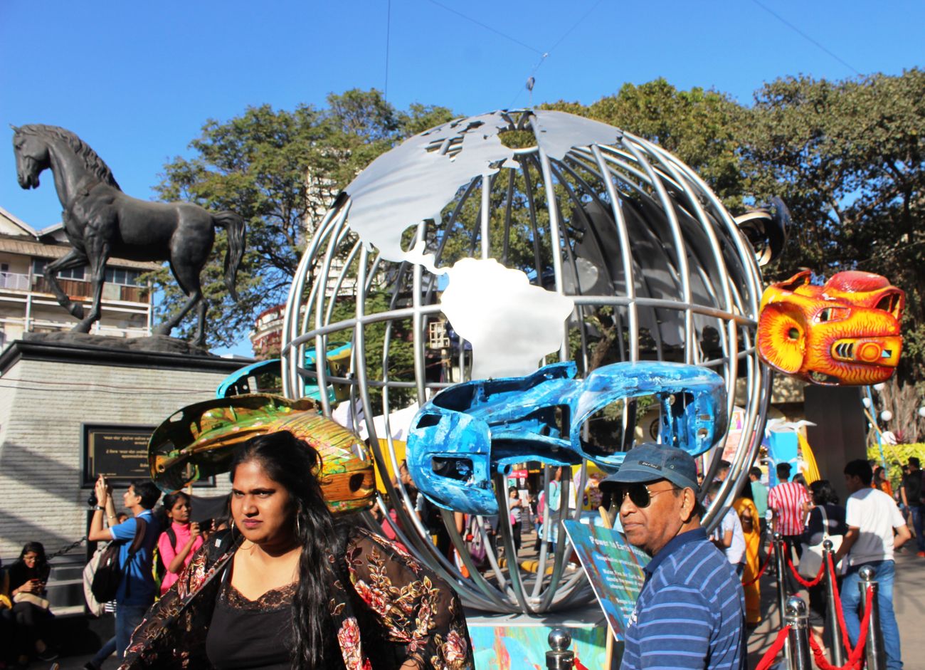 An eloquent representation of planet Earth with silver metal. It is an art set up installed near the statue titled 'Spirit of Kala Ghoda', at the Kala Ghoda Arts Fest 