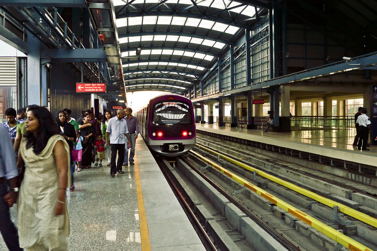 Bangaloreans taking comfort in the new mode of rail transportation system at MG Road Metro Railway Station. It is a station on the Purple Line of the Namma metro