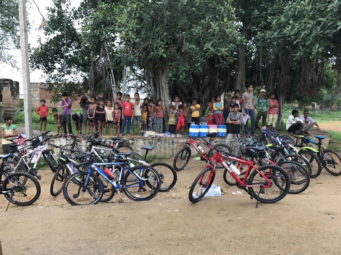 Children gather to look at the foreigners who arrived in their village during the cycle tour