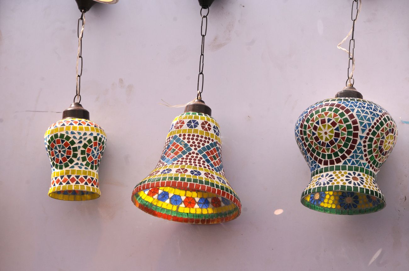 Very colorful and pretty lamps hanging on the wall for sale during the Kala Ghoda Arts Festival in Mumbai, Maharashtra, India. The annual Kala Ghoda Arts Festival is the most popular cultural festival and is well liked for its edgy installations, performances and discussions