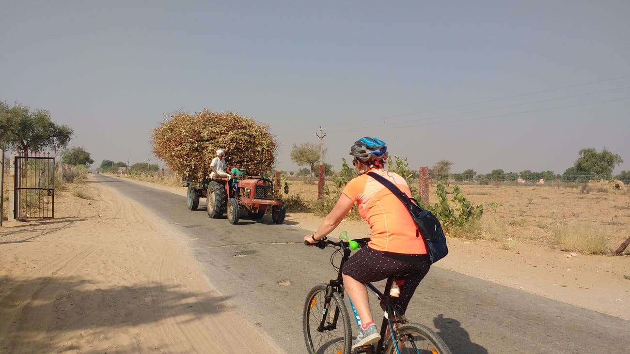 Cycling past a loaded tractor