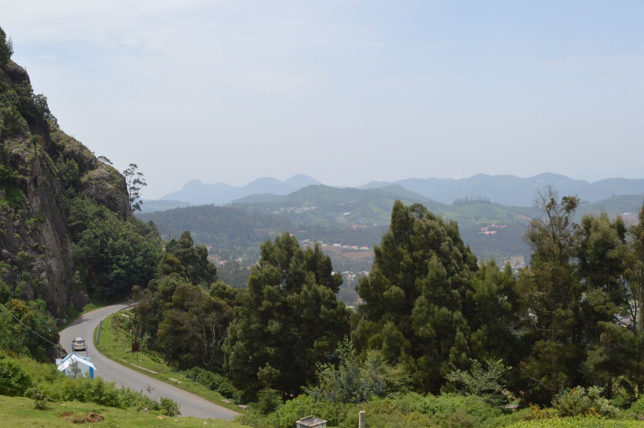 Kotagiri offers a scenic viewpoint from its hills, surrounded with dense green forests and foggy trails in Tamil Nadu, India
